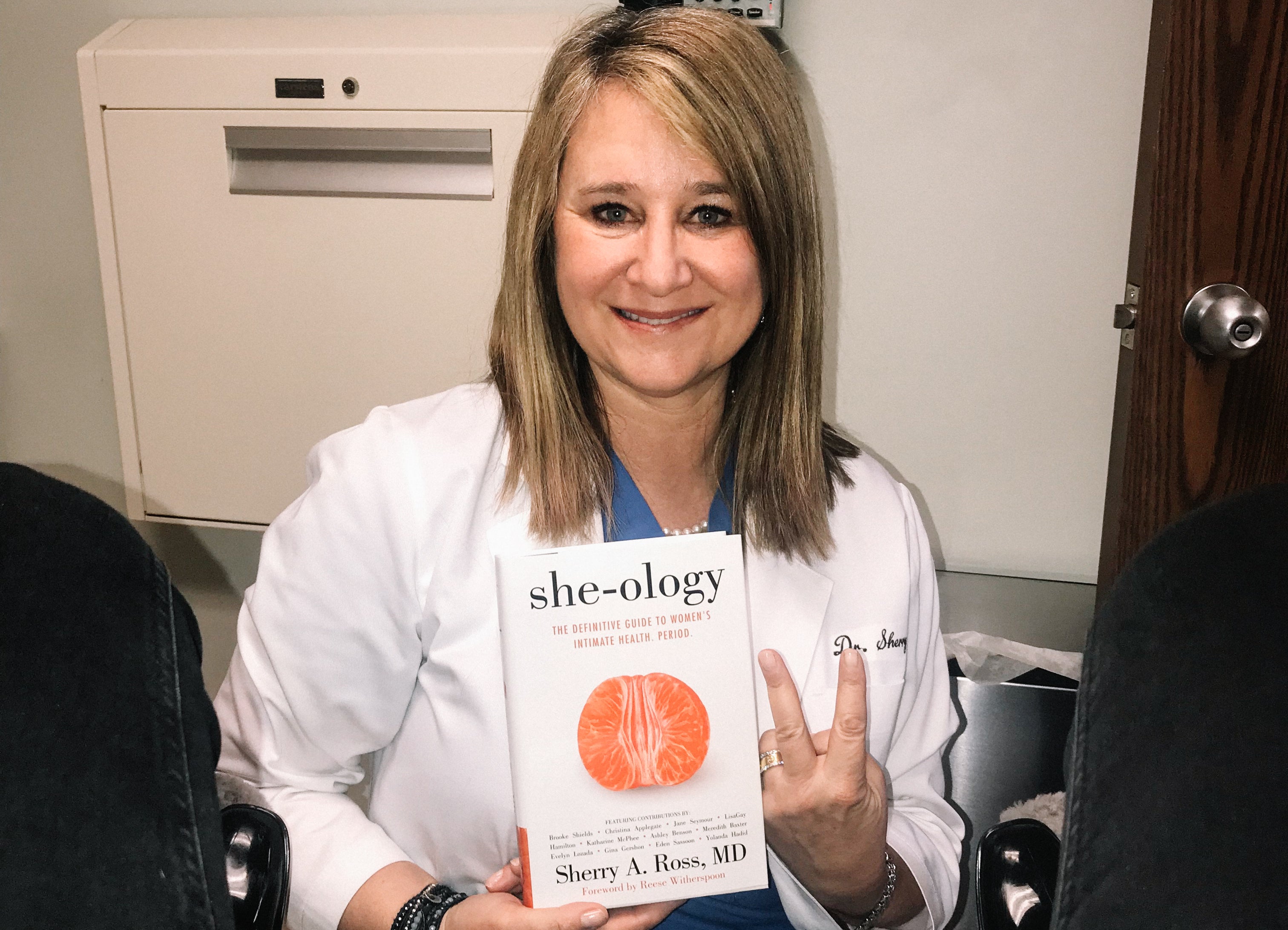 Photograph of Dr Sherry Ross MD holding her book She-ology