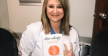 Photograph of Dr Sherry Ross MD holding her book She-ology