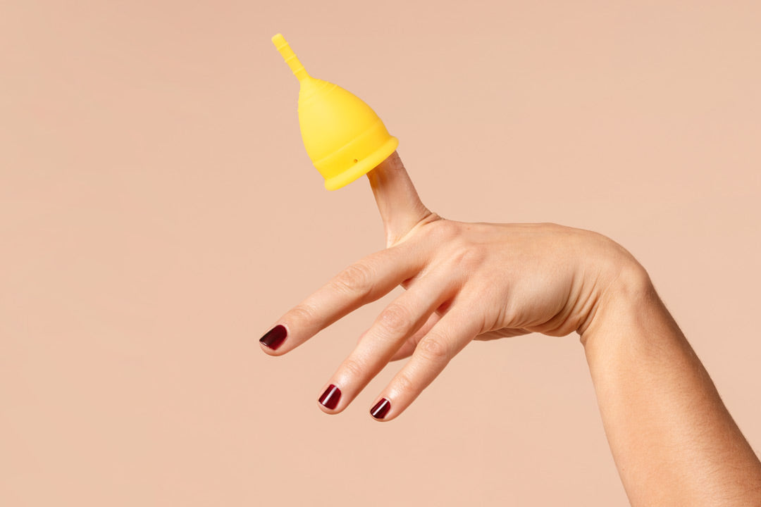 Yellow period cup in hand