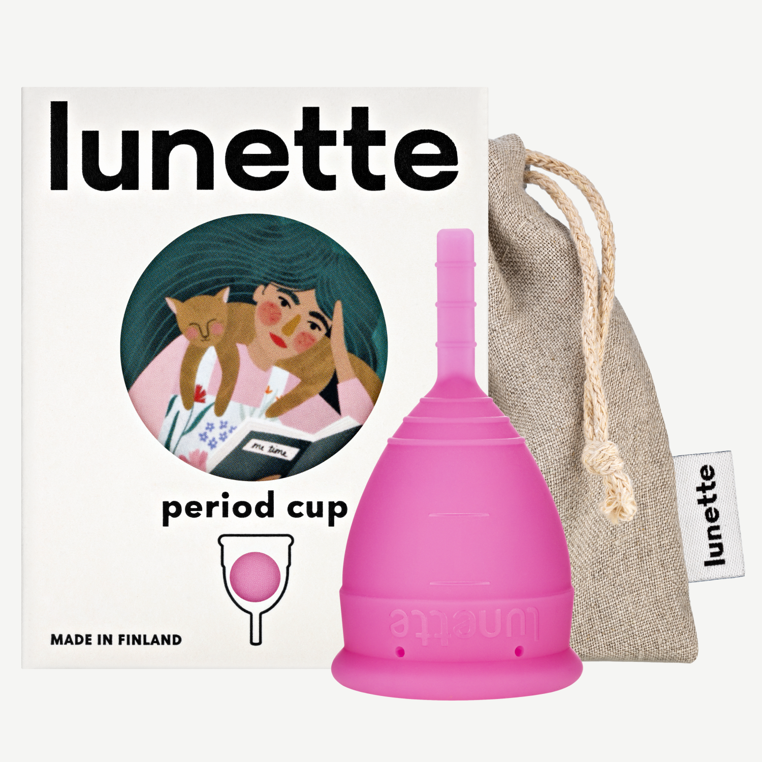 A pink Lunette period cup displayed alongside its packaging box with a floral design and a linen storage pouch. The box includes the text 'period cup', 'made in Finland', and the brand name 'Lunette'.